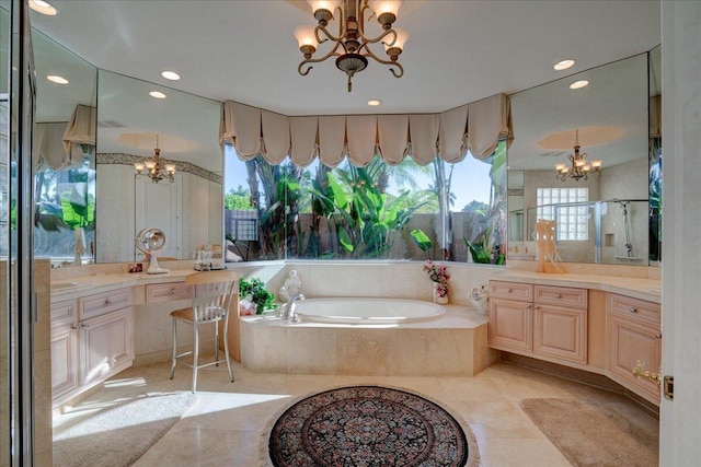 bathroom featuring tile patterned floors, vanity, independent shower and bath, and a notable chandelier