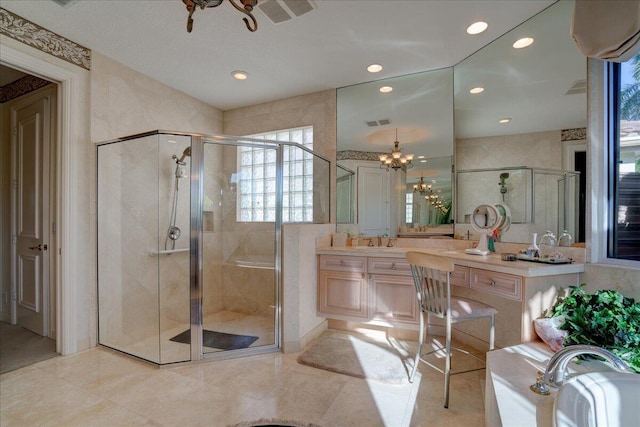 bathroom with shower with separate bathtub, vanity, and a notable chandelier