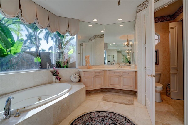 bathroom featuring vanity, tile patterned floors, toilet, tiled tub, and a chandelier