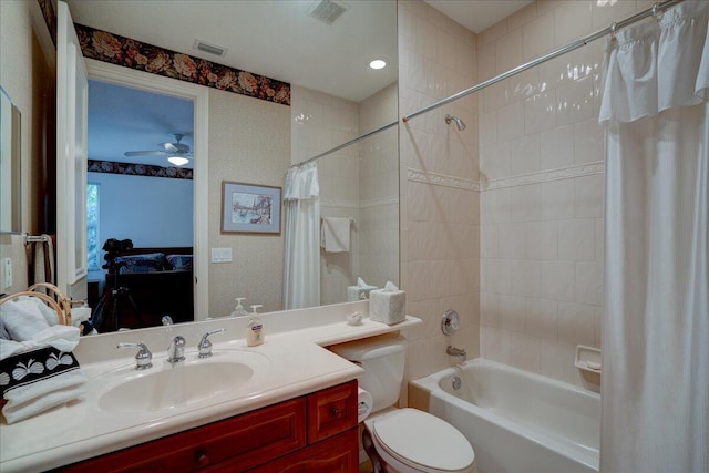 full bathroom featuring vanity, ceiling fan, toilet, and shower / bath combo with shower curtain