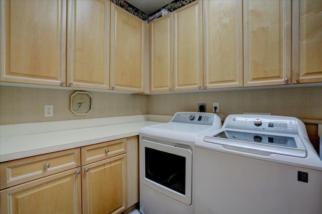 laundry room featuring cabinets and washing machine and clothes dryer