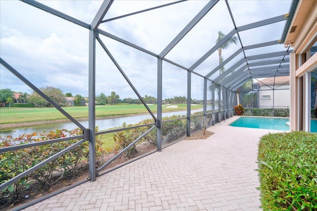 view of pool featuring a water view and glass enclosure