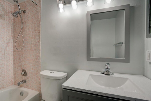 full bathroom featuring vanity, tiled shower / bath combo, and toilet