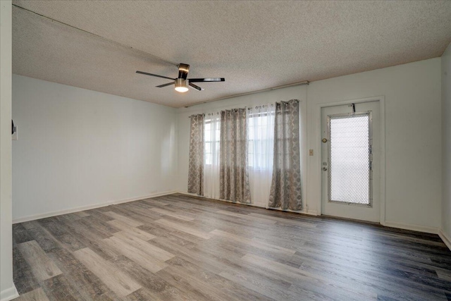 unfurnished room featuring ceiling fan, hardwood / wood-style floors, and a textured ceiling