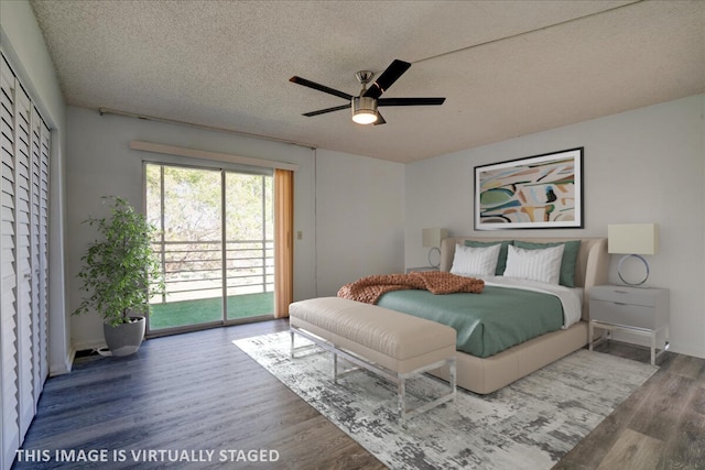 bedroom with hardwood / wood-style flooring, ceiling fan, access to exterior, and a textured ceiling