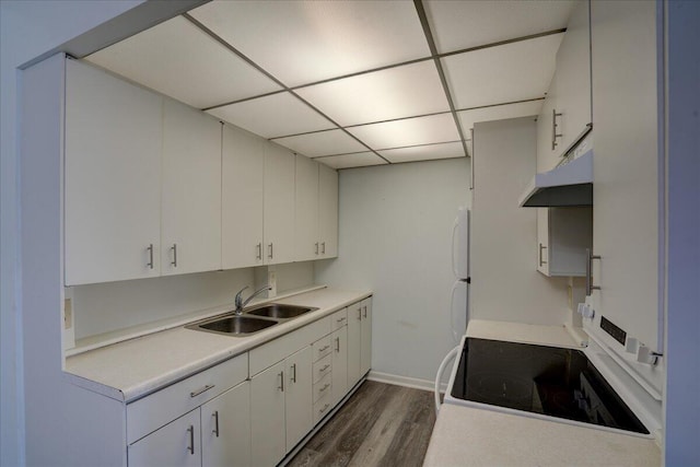 kitchen with a drop ceiling, dark wood-type flooring, sink, white range with electric stovetop, and white cabinetry