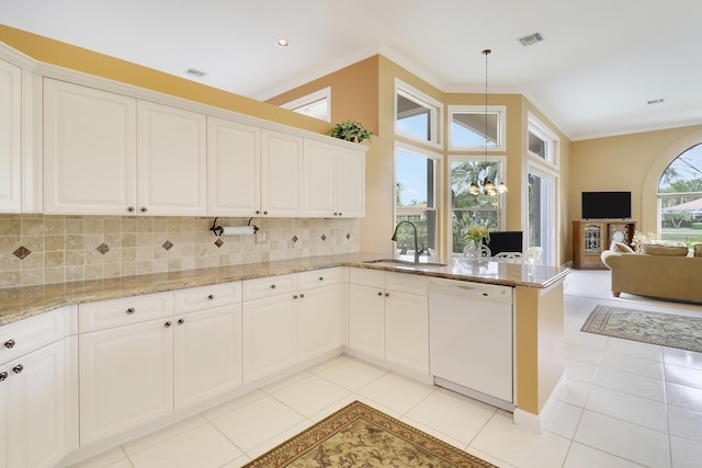 kitchen with lofted ceiling, white cabinetry, dishwasher, pendant lighting, and backsplash