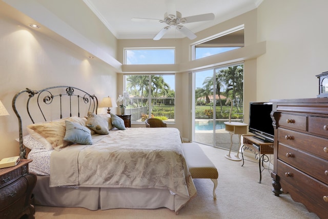 carpeted bedroom with a towering ceiling, access to outside, ornamental molding, and ceiling fan