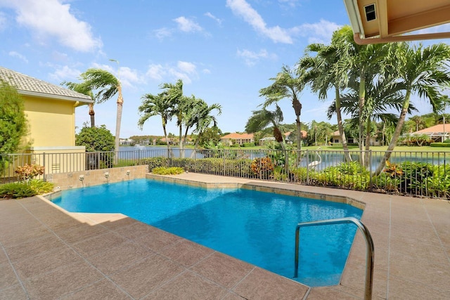 view of pool with a water view and a patio area