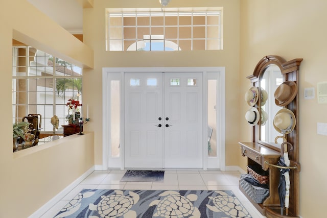 foyer featuring a high ceiling and light tile patterned floors