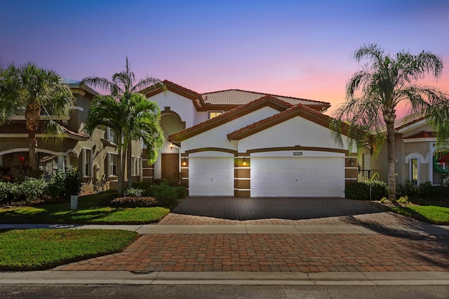 mediterranean / spanish house featuring a garage