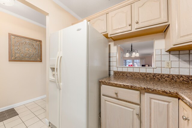 kitchen featuring white fridge with ice dispenser, an inviting chandelier, tasteful backsplash, light tile patterned floors, and ornamental molding