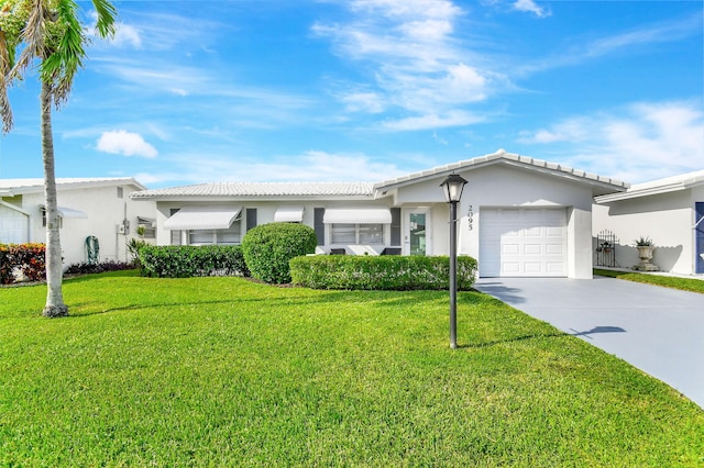 ranch-style home featuring a garage and a front lawn