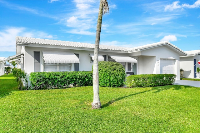 ranch-style house with a front yard and a garage