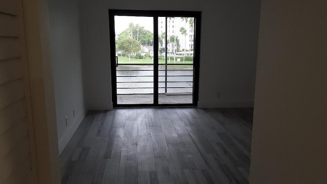 empty room with dark hardwood / wood-style flooring