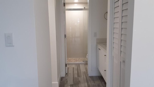 hallway with dark hardwood / wood-style flooring