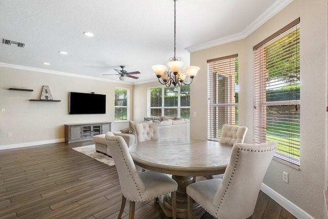 dining space with a textured ceiling, dark hardwood / wood-style flooring, ceiling fan with notable chandelier, and ornamental molding