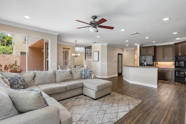 living room with a textured ceiling, hardwood / wood-style floors, ceiling fan with notable chandelier, and ornamental molding