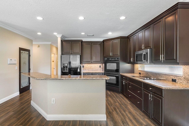 kitchen with dark hardwood / wood-style flooring, dark brown cabinetry, crown molding, black appliances, and a center island