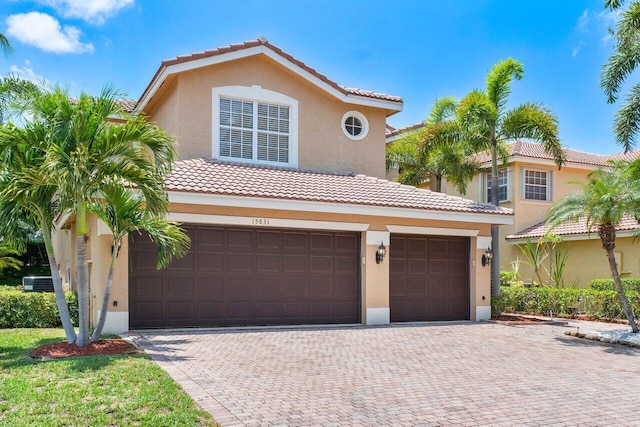 mediterranean / spanish-style home with a garage