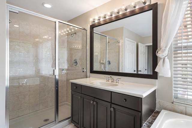 bathroom with vanity and separate shower and tub