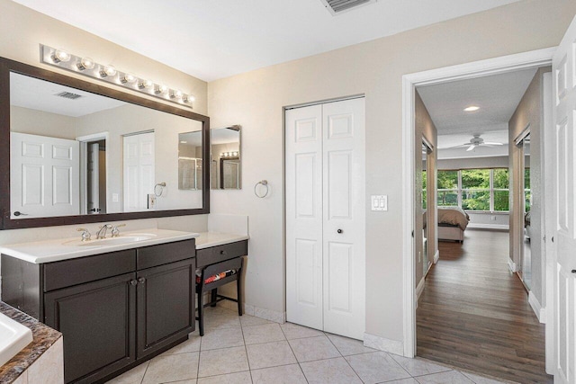 bathroom with ceiling fan, vanity, and wood-type flooring