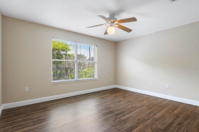 spare room featuring dark hardwood / wood-style floors, ceiling fan, and a textured ceiling