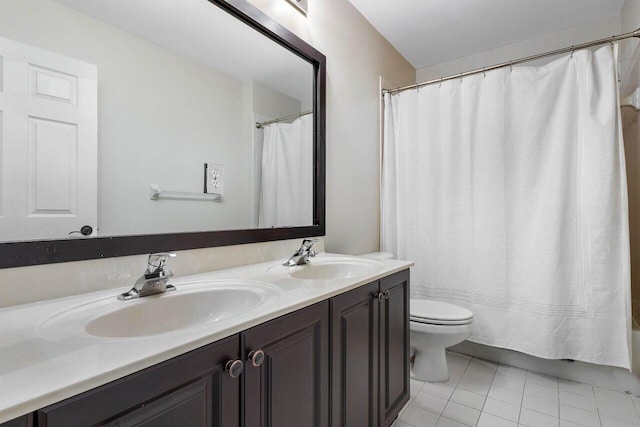 full bathroom with tile patterned floors, vanity, toilet, and shower / bath combo with shower curtain