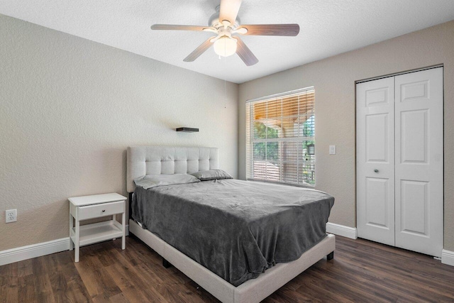 bedroom with ceiling fan, dark hardwood / wood-style floors, and a textured ceiling