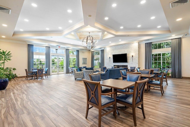 dining area featuring light hardwood / wood-style flooring, plenty of natural light, and a notable chandelier