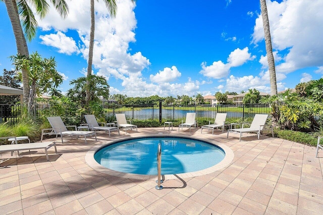 view of pool featuring a water view and a patio area