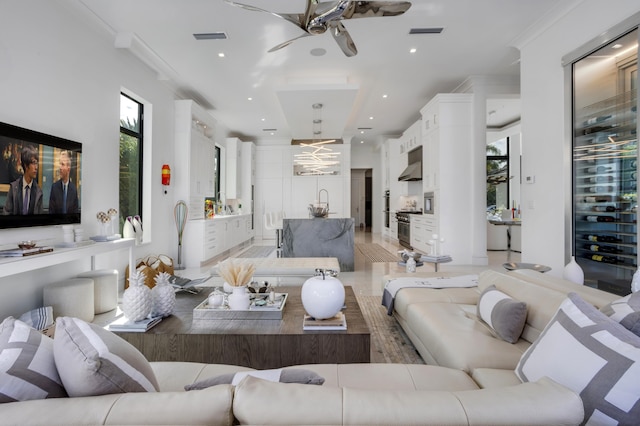 living room featuring wine cooler, crown molding, and ceiling fan