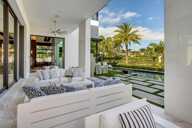 balcony with outdoor lounge area, ceiling fan, and a patio area