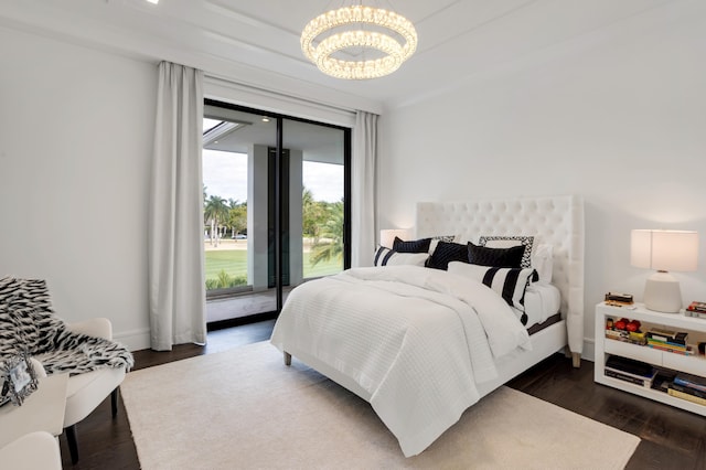 bedroom with a chandelier, dark hardwood / wood-style flooring, and access to outside