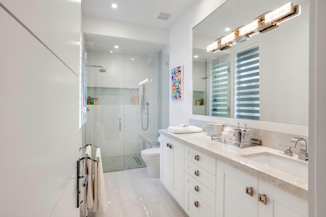 bathroom with vanity, toilet, and walk in shower