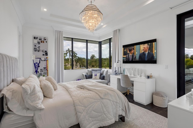 bedroom featuring a chandelier, dark hardwood / wood-style floors, a raised ceiling, and crown molding