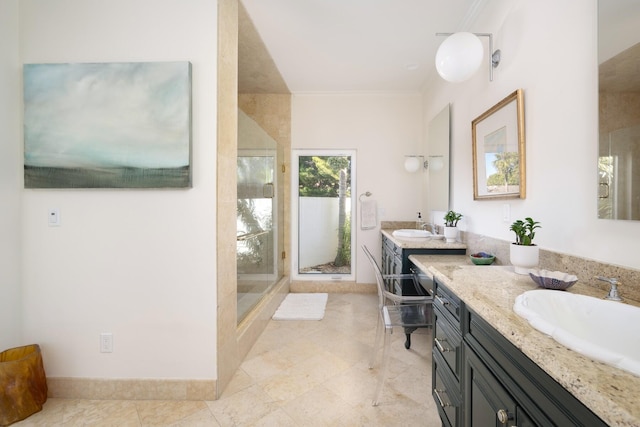 bathroom with tile patterned flooring, vanity, a shower with door, and crown molding