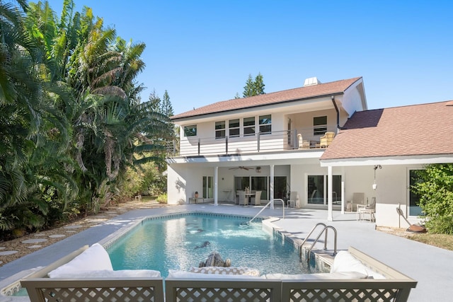 back of house featuring a balcony and a patio