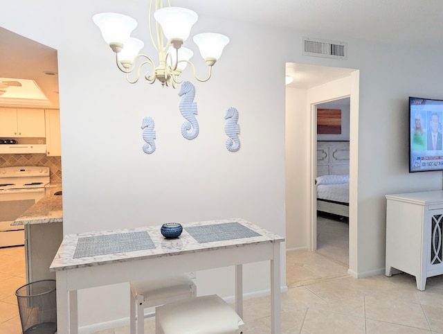 dining space featuring a chandelier and light tile patterned floors