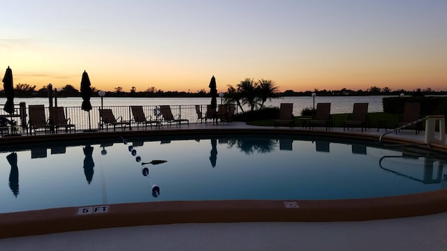 pool at dusk with a water view