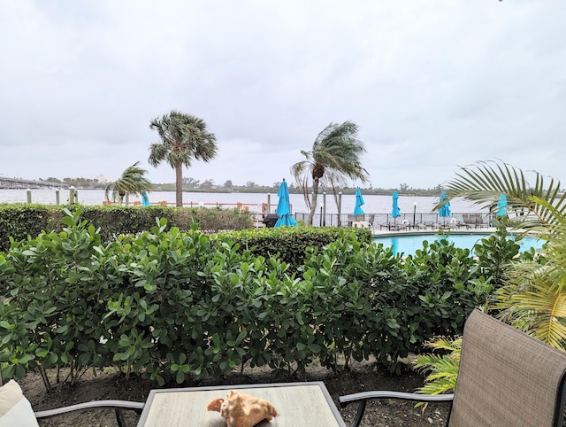 view of patio / terrace featuring a community pool and a water view