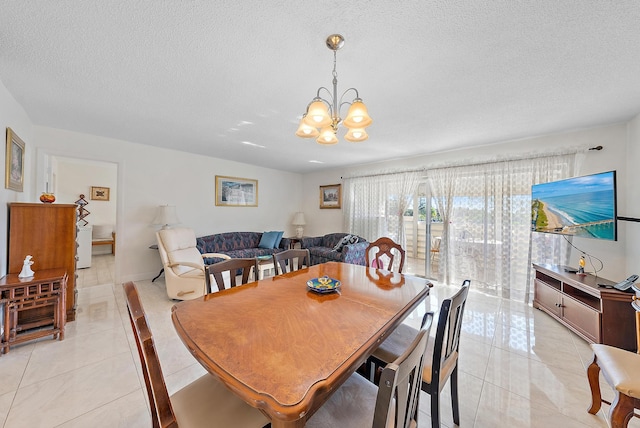 tiled dining room featuring a notable chandelier and a textured ceiling