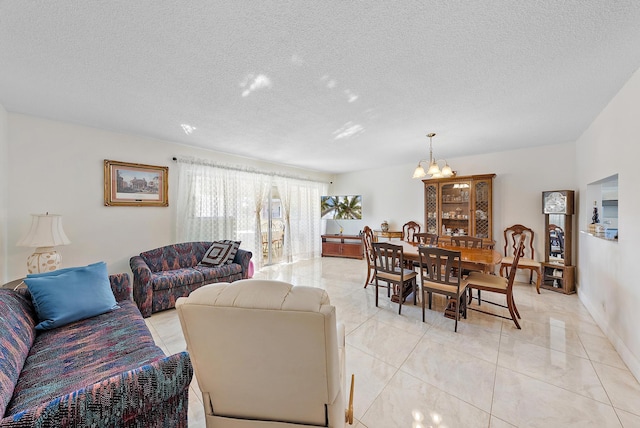 living room with a notable chandelier, light tile patterned floors, and a textured ceiling