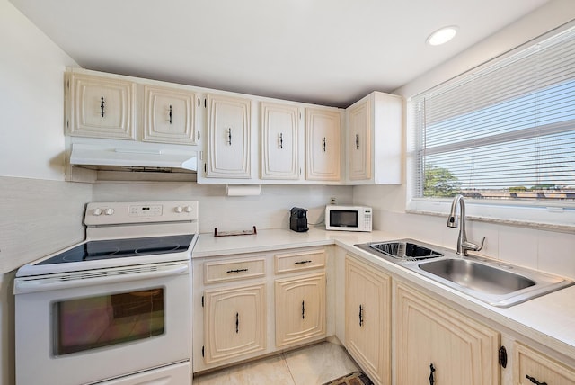 kitchen with backsplash, white appliances, and sink