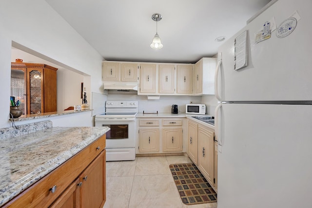 kitchen featuring pendant lighting, light stone counters, white appliances, and light tile patterned floors