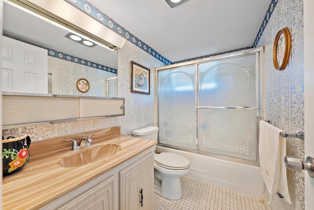 full bathroom with tile patterned flooring, vanity, enclosed tub / shower combo, and toilet