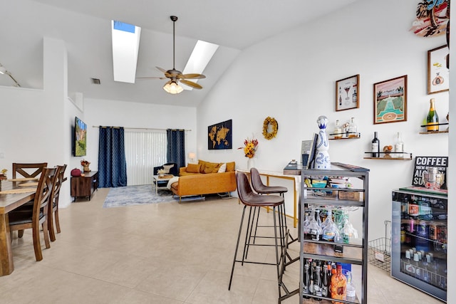 interior space featuring bar, ceiling fan, lofted ceiling, and beverage cooler