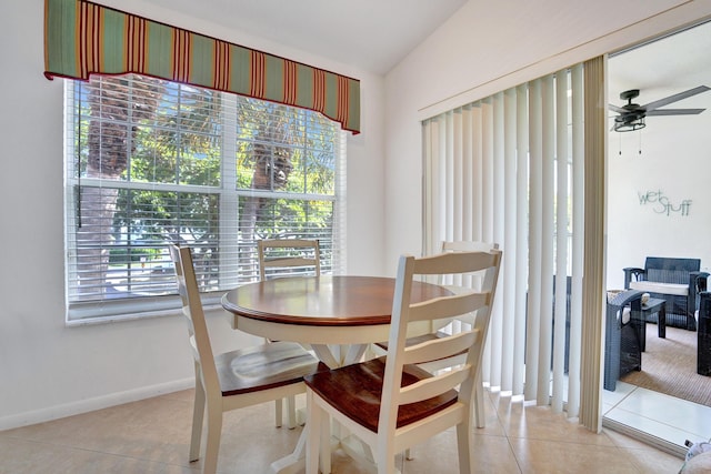 tiled dining space featuring a wealth of natural light, ceiling fan, and lofted ceiling