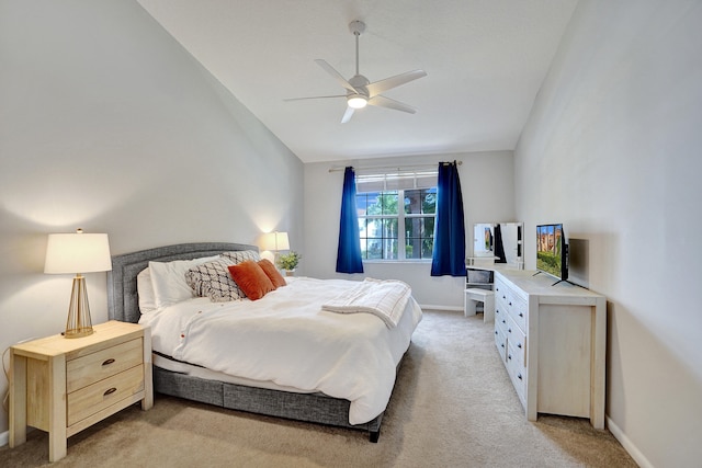 bedroom with lofted ceiling, light colored carpet, and ceiling fan