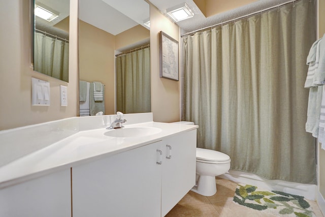 bathroom with tile patterned flooring, vanity, curtained shower, and toilet